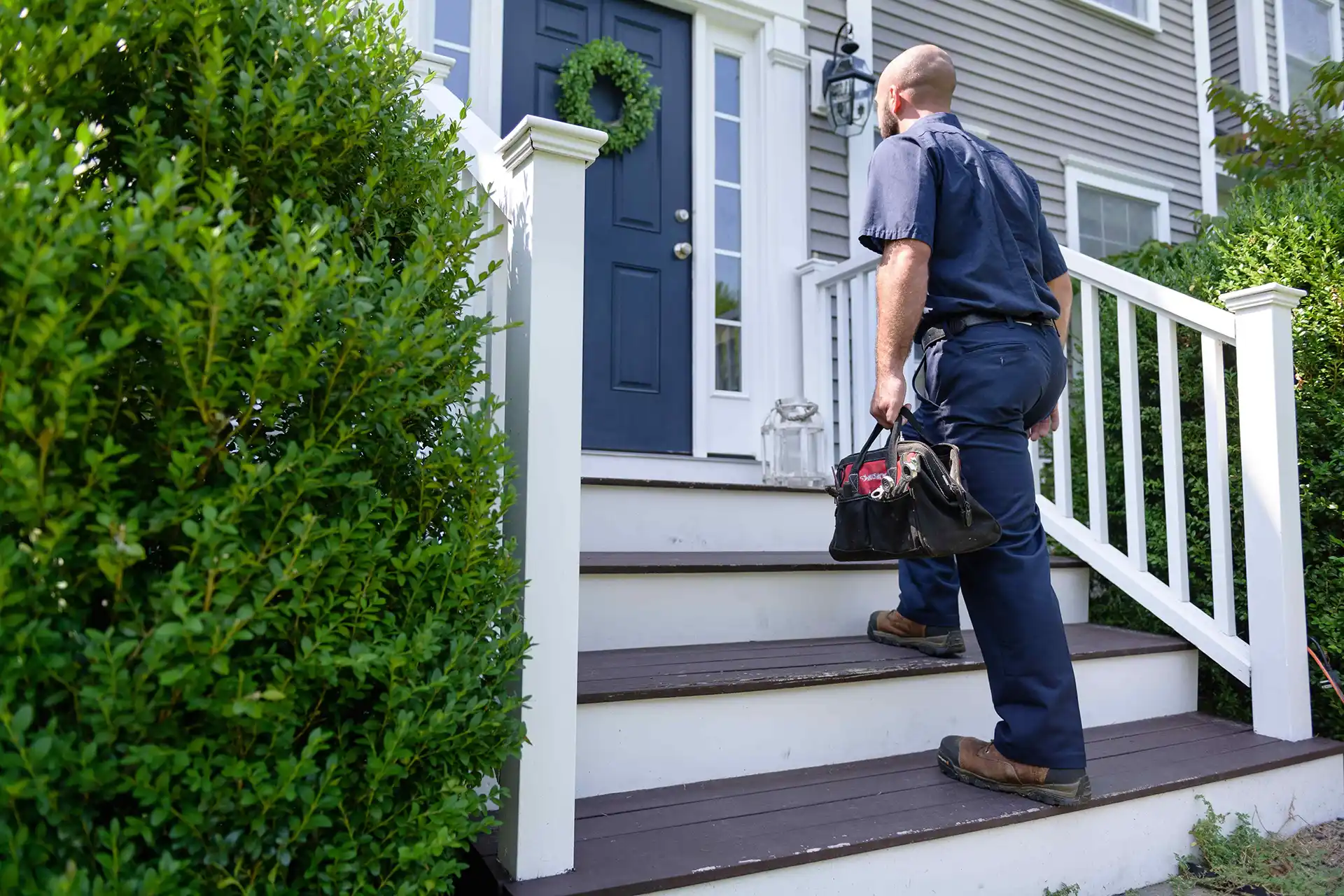 A Dead River employee approaches a house